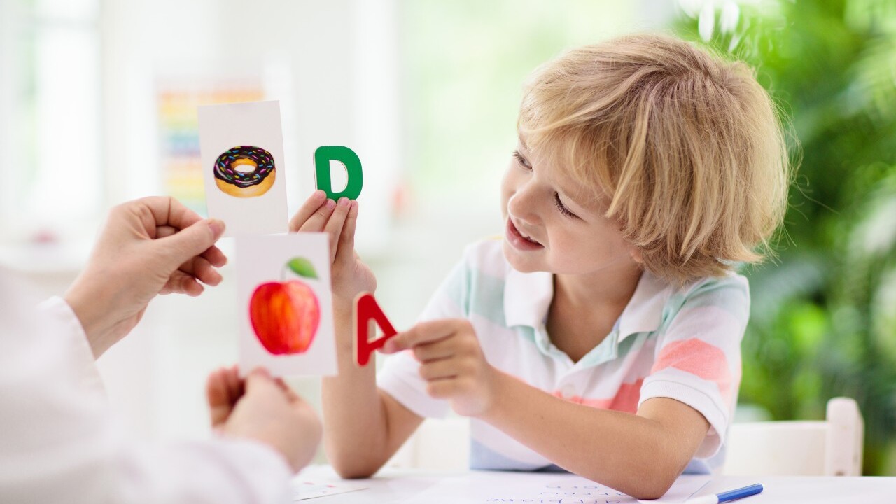 Teacher and student reviewing letters.