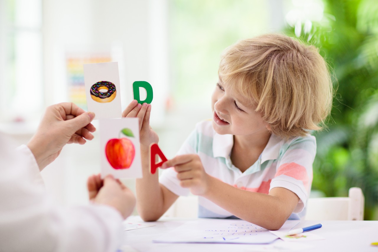 Teacher and student reviewing letters.